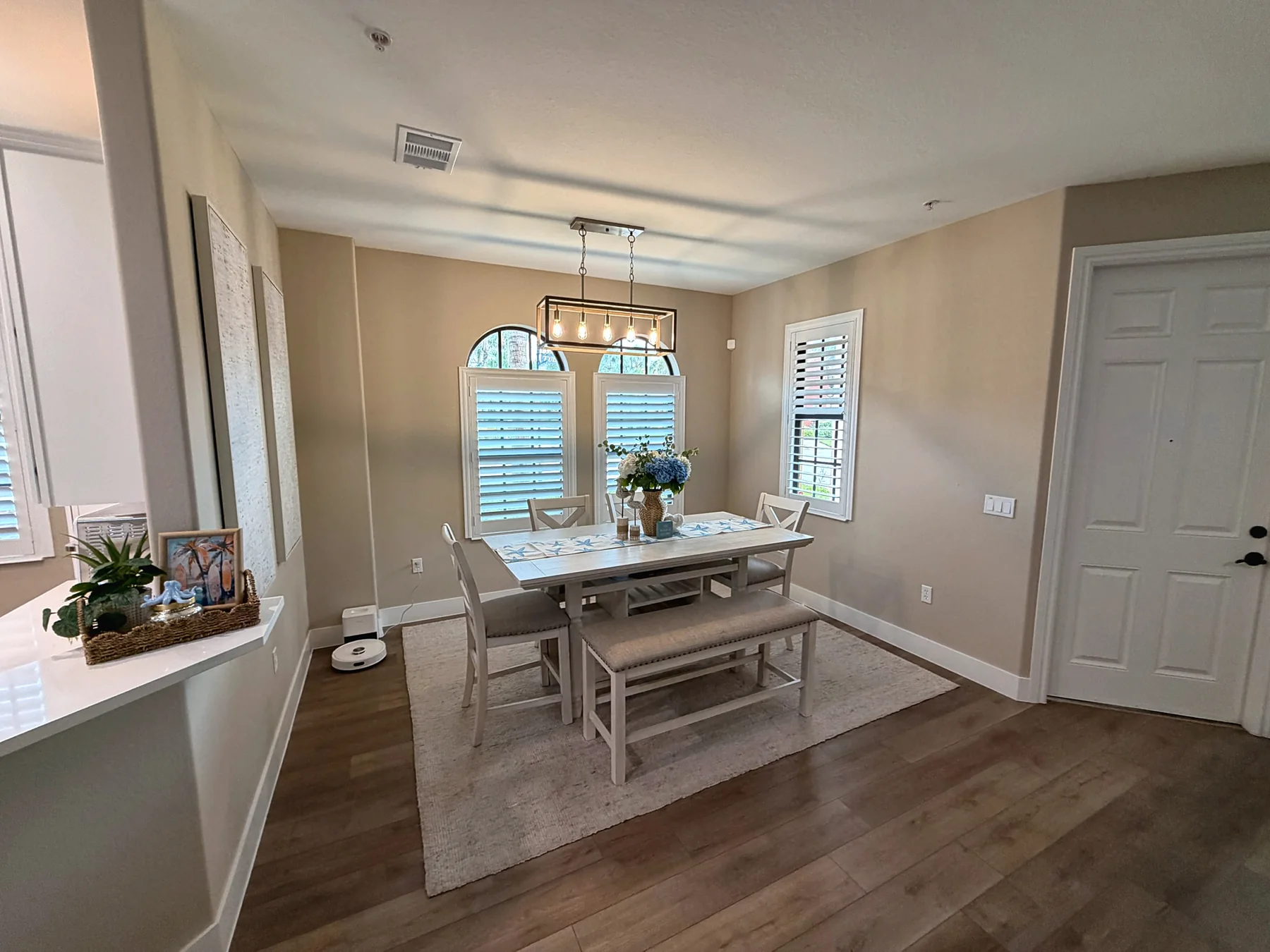 Dining area beneath arched windows